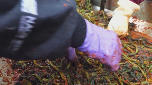 Preparing Kimchi with fresh vegetables in a kitchen