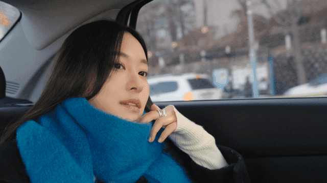 Woman in a taxi looking out the window