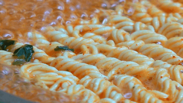 Spicy ramen boiling in a pot