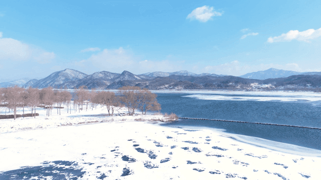 Snow-covered landscape with a frozen lake