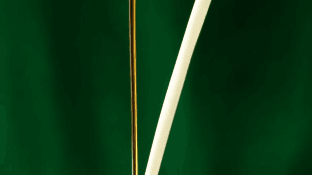 White milk poured against a green screen