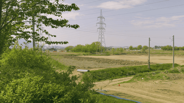 Rural construction site scene with power lines