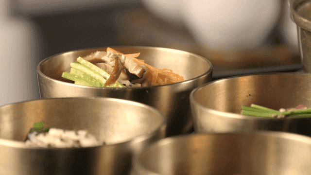 Korean side dishes served in brassware