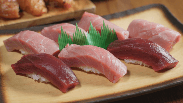 Various tuna sushi served on wooden plate