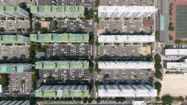 Aerial view of large apartment complex and parking lot