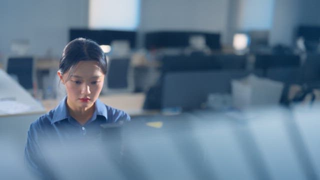 Woman using a coffee machine in an office