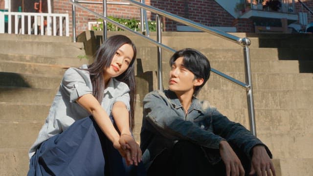 Couple sitting on outdoor steps in sunlight