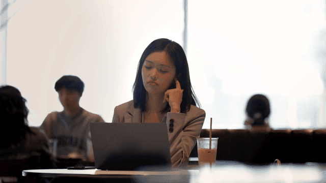 Working woman working on laptop at cafe