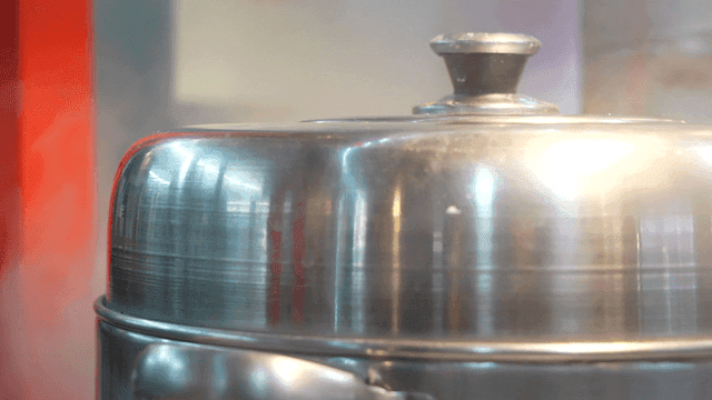 Steam rising from a metal pot lid