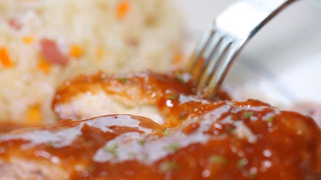 Lifting cheese pork cutlet with a fork