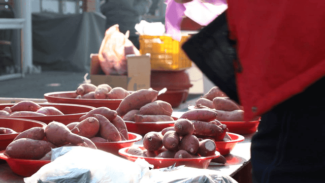 Sweet potatoes displayed at an outdoor market