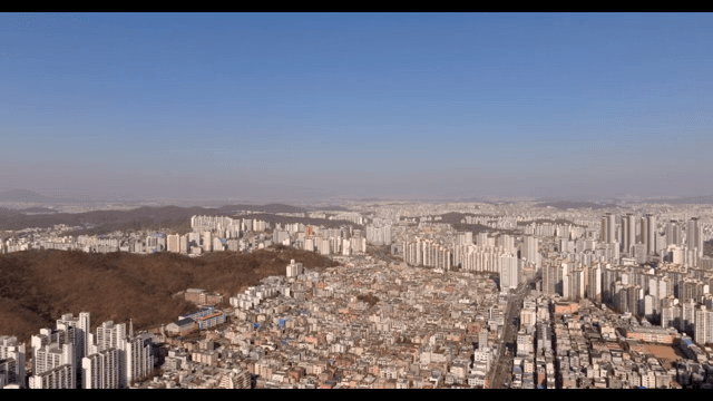 Expansive cityscape with surrounding hills