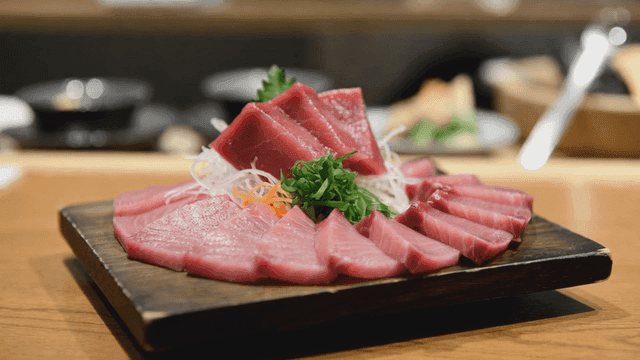 Fresh sashimi slices on a wooden platter