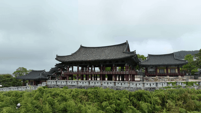 Traditional Korean pavilion surrounded by trees