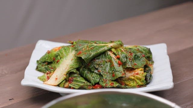 Korean kimchi and clear yukgaejang on a table