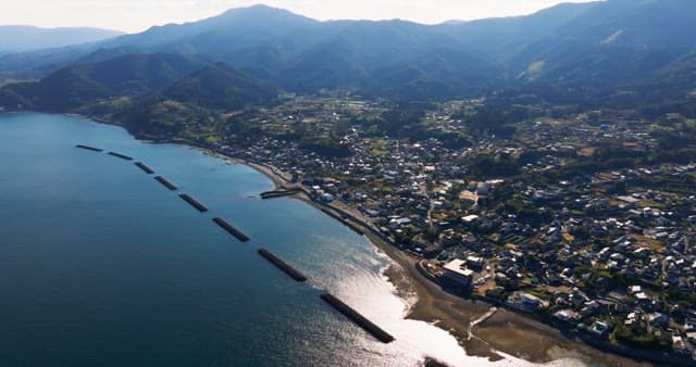 Coastal village with mountains in the background