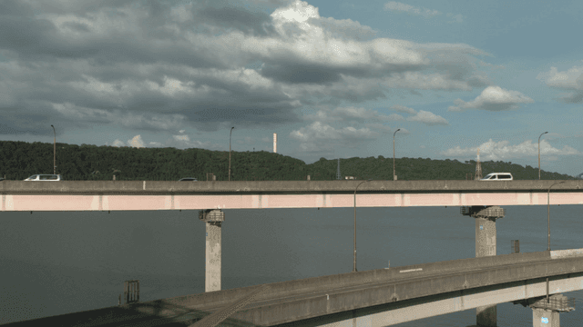Cars crossing bridge over river
