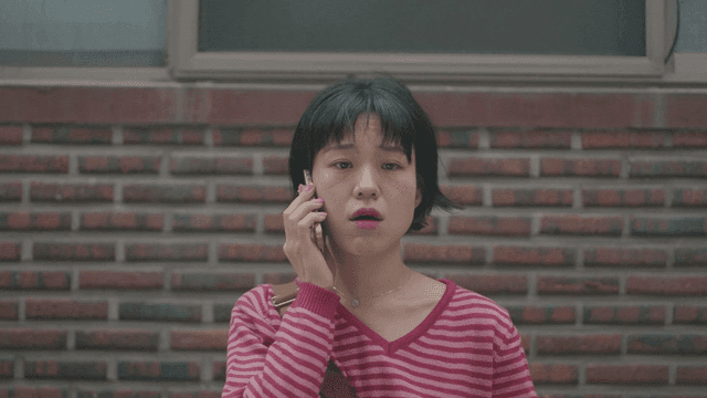 Woman smoking while talking on the phone outdoors