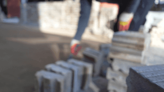Construction worker arranging bricks