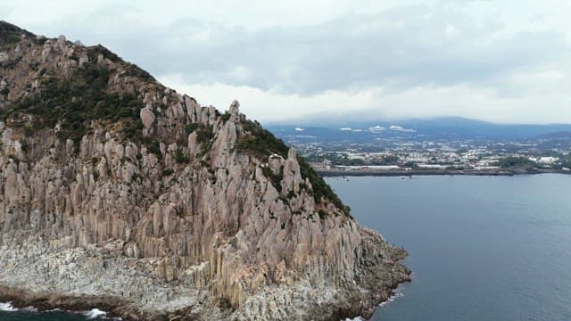 Coastal island with a distant city view