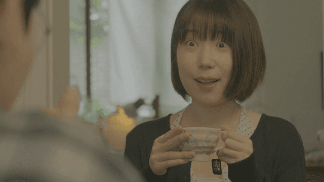 Short-haired woman enjoying tea at cafe