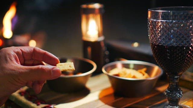 Enjoying crackers at a cozy table with candles and wine glasses