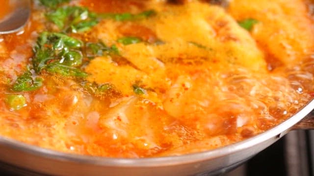 Spicy fish stew with fresh vegetables and trout oil