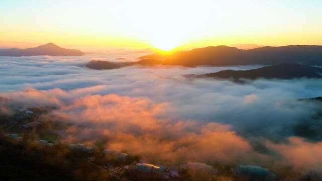 Sunrise Seen from the Clouds over the Mountains