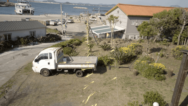 Coastal village with a ferry and truck