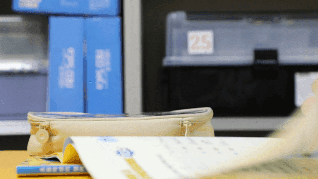 Elementary school students solving workbooks in classroom