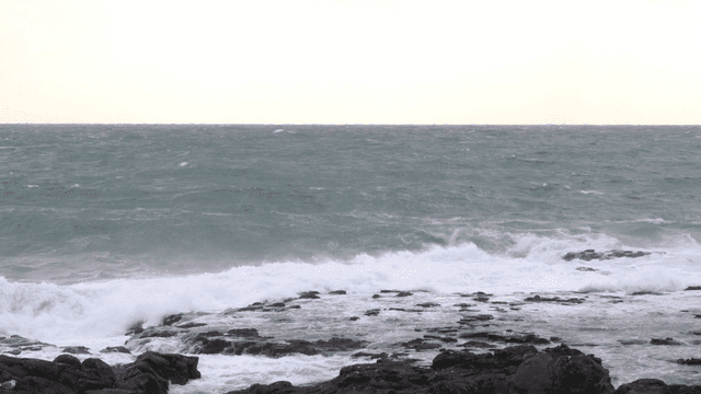 Strong waves crashing against rocky shore
