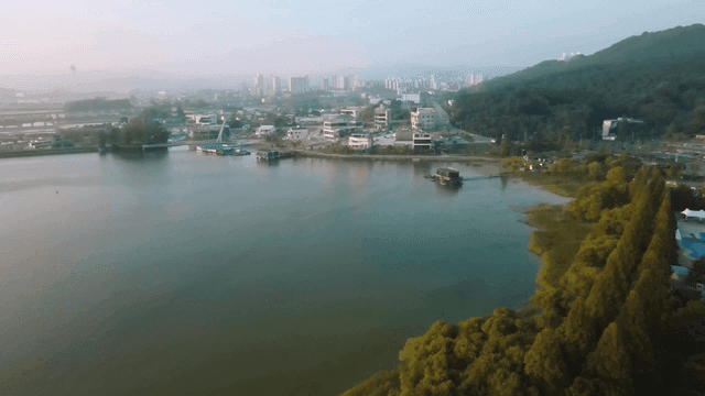 Serene lakeside city landscape and sunrise on hill