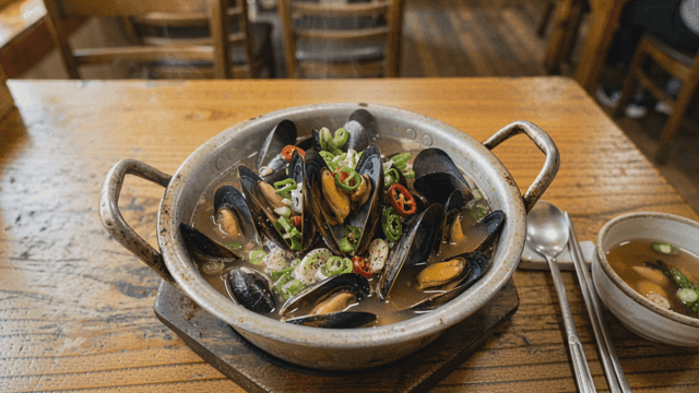 Steaming mussel soup in a cozy restaurant