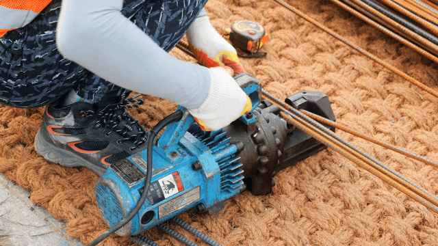Worker using a rebar cutter on site