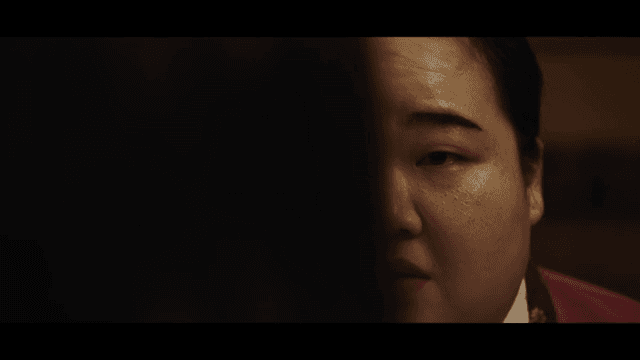 Woman wearing a hanbok speaking with a serious expression