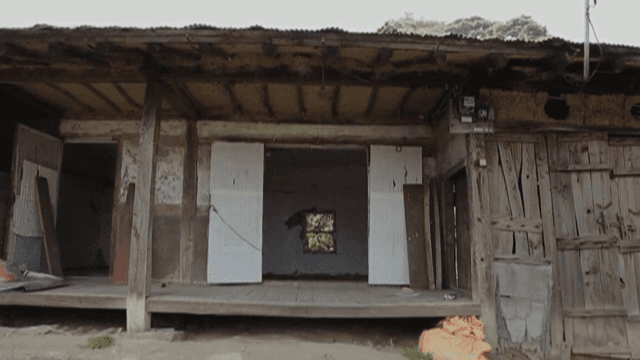 Old wooden house with open doors