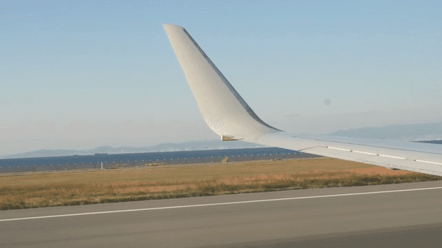 Airplane wing view during takeoff