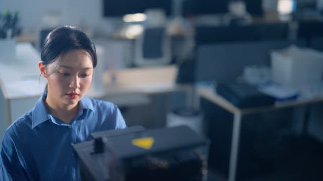 Woman making coffee from office coffee machine