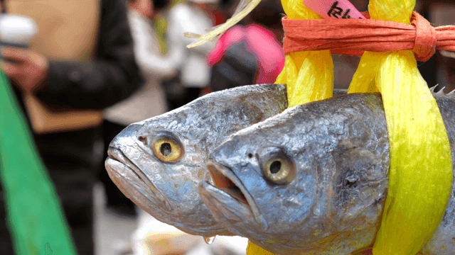Fish hanging in a bustling market