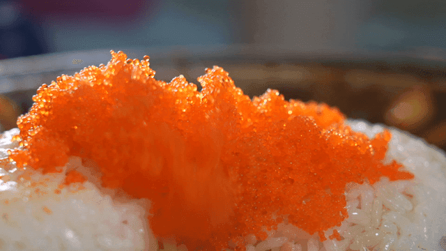Rice topped with vibrant flying fish roe