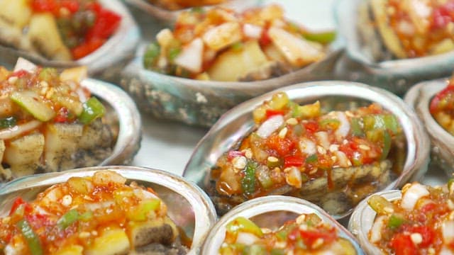 Butter-grilled abalone on a plate with a mouthwatering seasoning