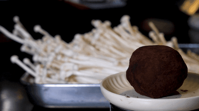 Enoki mushrooms and truffle mushrooms on plate