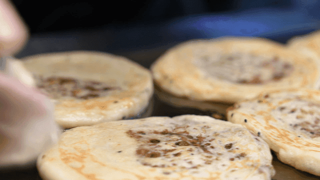 Korean pancakes cooking on a griddle