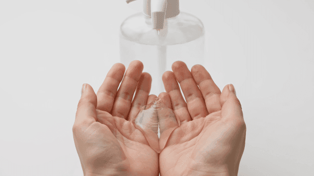 Hands sprayed with disinfectant