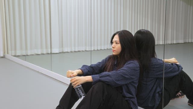 Woman drinking water indoors