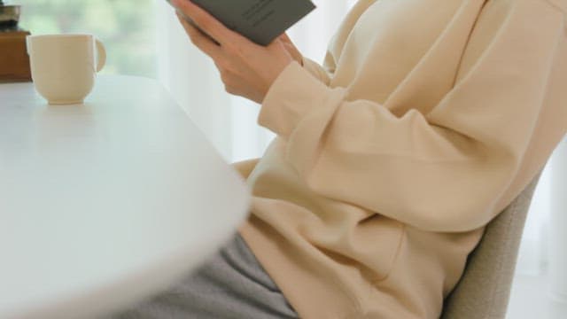 Woman Reading a Book in a Bright Room