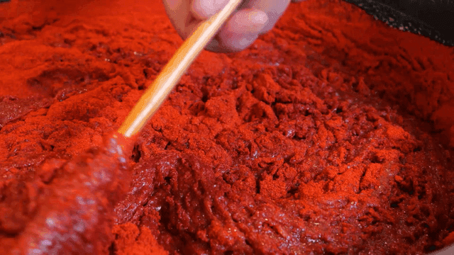 Mixing red pepper paste in a large bowl