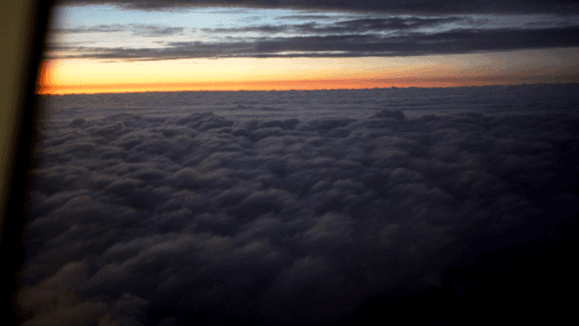 Sunset view above the clouds from an airplane
