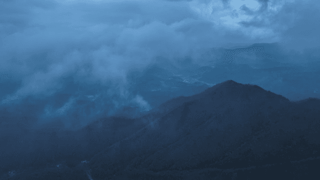 Misty mountains under a cloudy sky