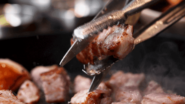 Grilled pork neck cut with scissors